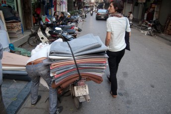 Guy loads Textiles on Scooter